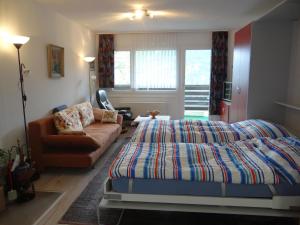 a bedroom with a bed and a couch at Apartment Zügstrasse 4 by Interhome in Engelberg