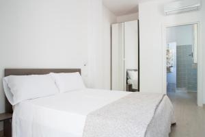 a white bedroom with a white bed and a mirror at Villa Lara in Polignano a Mare +25 photos