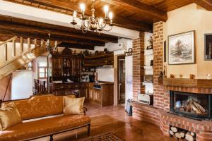 a living room with a couch and a fireplace at Moslavačka Priča Holiday Homes in Mala Ludina