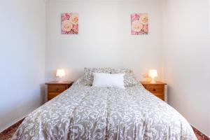 ein Schlafzimmer mit einem Bett mit zwei Nachttischen in der Unterkunft Apartamento Cala Mar in La Cala del Moral