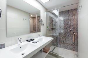 a bathroom with a sink and a shower at Hotel Riu Costa del Sol - All Inclusive in Torremolinos