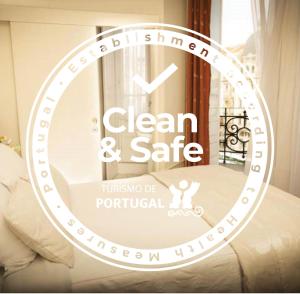 a sign that says clean and safe in a room at Hotel Aliados in Porto