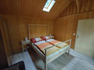a bedroom with a bed in a wooden room at Ferienhaus Eschenallee in Wendisch Rietz