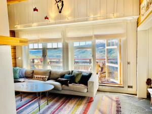 a living room with a couch and a table at Åre Travel - Tottvillan in Åre