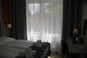 Postel nebo postele na pokoji v ubytování Hotel CK Park