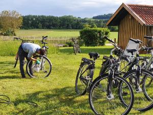 a person is washing a bike in a field at Hotel An Der Brunnader - Ihr perfekter Rückzugsort in der Bayrischen Toskana in Bad Birnbach