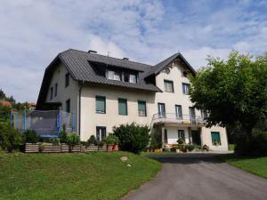 a large white house with a black roof at Neubauerhof in Liebenfels