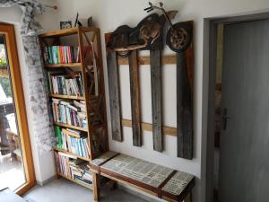 a book shelf filled with books next to a bench at Ferienwohnung Daniela in Bad Aussee