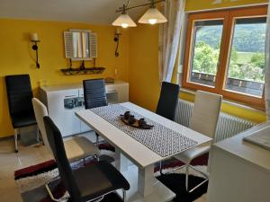 a dining room with a white table and chairs at Ferienwohnung Daniela in Bad Aussee