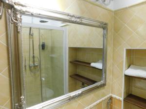 a bathroom with a shower and a mirror at Free Terrace in Piran