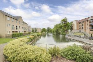 a view of a river in a city with buildings at Penthouse Apartment Little Paxton - 47 Skipper Way in Saint Neots