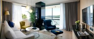 a living room with a white couch and chairs at Hotel Excelsior in Dubrovnik
