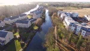 an aerial view of a river in a city at Penthouse Apartment On The River - 65 Skipper Way in Saint Neots