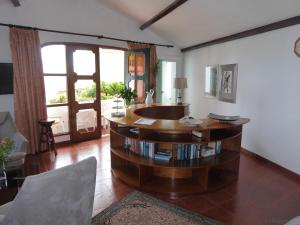 a living room with a table with books at Villa Erika Madeira in Caniço
