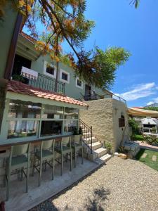 a building with chairs in front of it at ZEVKLİLER ALAÇATI boutique hotel & fine dining in Alacati