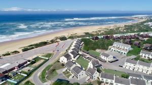 an aerial view of a beach with houses and the ocean at 42 Settler Sands Beachfront Accommodation Sea and River View in Port Alfred