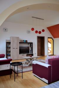 a living room with a couch and a table at Rozsi Mama in Sovata