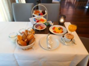 a table with a tray of breakfast food on it at Hotel Goldenes Rad in Ulm