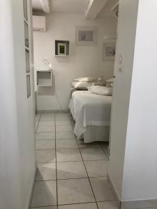 a bedroom with a bed and a tiled floor at La Tanière de l'Ours Blanc Aubagne-Cassis-Aix en Provence in Aubagne