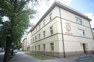 a white building with a sign on the side of it at Solanki Medical SPA in Inowrocław