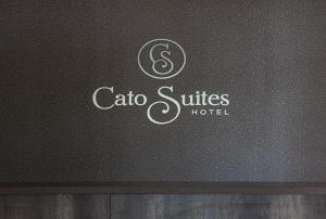 
a black and white sign on a white wall at The Cato Suites Hotel in Durban

