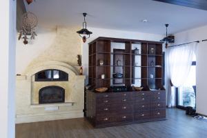 a living room with a fireplace and a entertainment center at Vatra Boiereasca in Cacica
