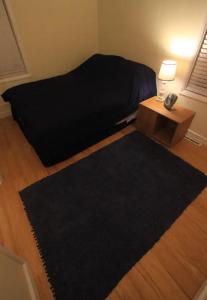 a bedroom with a bed and a table with a phone at Superp South End Apartment in Burlington
