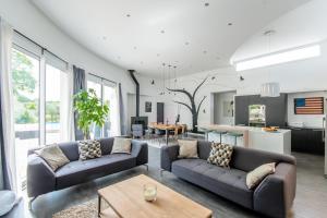 a living room with two couches and a table at Gites d'Armor in Treguidel