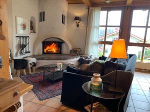 a living room with a fireplace and couches at Landhotel Villa Foresta in Braunlage