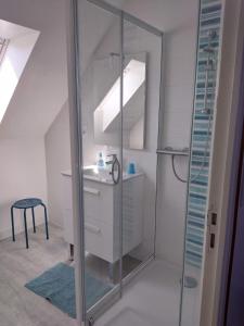a bathroom with a glass shower and a sink at Vent des Grèves in Pontorson