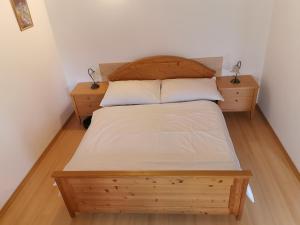 a bedroom with a wooden bed with two night stands at Apartmány Dolní Moravice in Dolní Moravice