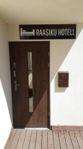 a door to a hotel with a sign above it at Raasiku Hotell in Raasiku