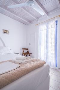 a bedroom with two beds and a window at Κymanemi Folegandros in Agali +16 photos