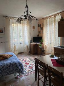 a bedroom with a table and a bed and a dining room at La Casina Di Jessica in Aulla