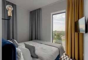 Łóżko lub łóżka w pokoju w obiekcie Apartamenty Prymasa Residence