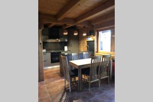 a kitchen and dining room with a table and chairs at ARKA in Belavići +25 photos