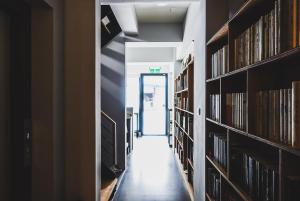 an empty hallway in a library with bookshelves at Ren Homestay in Hengchun