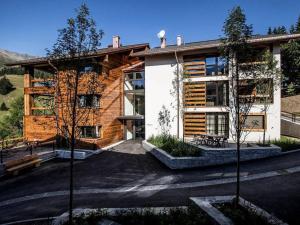 a large building with trees in front of it at Apartment Turrabuel 4-Bett Deluxe by Interhome in Parpan