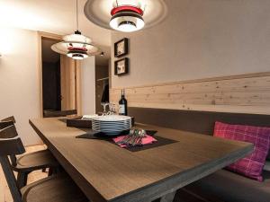 a dining room with a table with plates and glasses at Apartment Turrabuel 4-Bett Deluxe by Interhome in Parpan