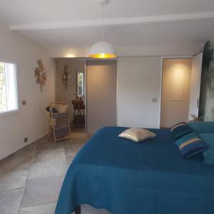 1 dormitorio con cama azul y manta azul en Villa Nais B&B en Bormes-les-Mimosas
