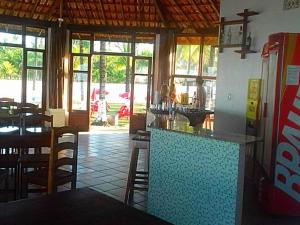 een restaurant met een bar en een aantal tafels en stoelen bij Pousada E Restaurante Doce Desejo in Ilhéus