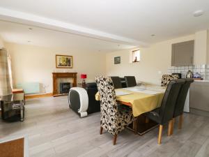 a dining room with a table and some chairs at Mulberry Manor in Hull