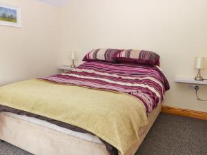 a bedroom with a large bed with two lamps on it at Daisy Nook in Hull