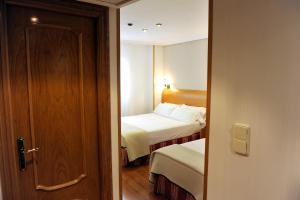 Postel nebo postele na pokoji v ubytování Hotel El Churra