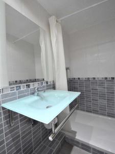 
a bathroom with a sink and a bath tub at BARCELONA GOTIC Guesthouse in Barcelona
