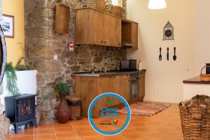 a kitchen with wooden cabinets and a counter top at Casa do Vale 2 in Peso da Régua