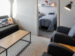 a living room with a mirror and a bed at Holiday Home Levin kunkku b8 by Interhome in Levi
