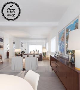 a living room with a table and a couch at LUXURY ALVOR PENTHOUSE in Alvor