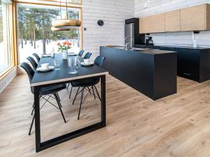 a kitchen with a table and chairs in a room at Holiday Home Villa gaissa by Interhome in Raattama +13 photos