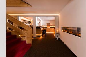 a staircase in a house with a view of a kitchen at Muntanella in Lech am Arlberg